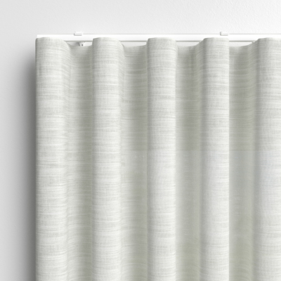 White, textured wave curtains on a white track 