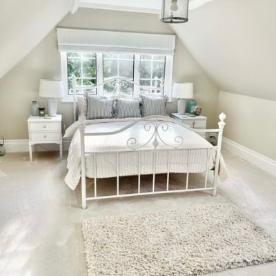 Modern living room with shelving and white shutters. 