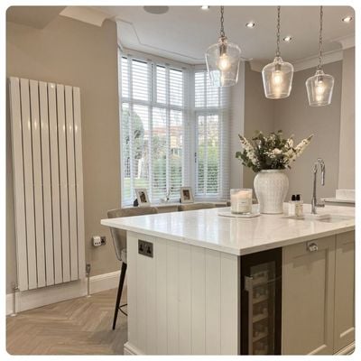 White wooden blinds in a dark grey panelled dining room 