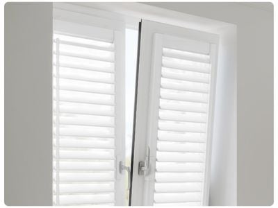 White wooden blinds in a dark grey panelled dining room 