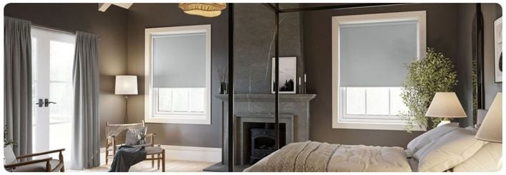 Grey blackout roller blinds in a black bedroom 