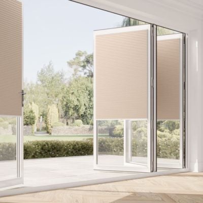 Beige, pleated, no-drill blinds on bifold doors