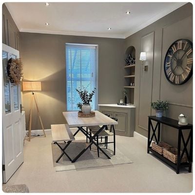 White wooden blinds in a dark grey panelled dining room 