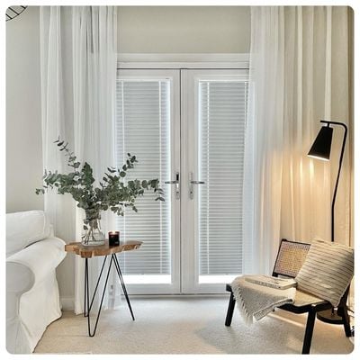 White wooden shutters in dining room 
