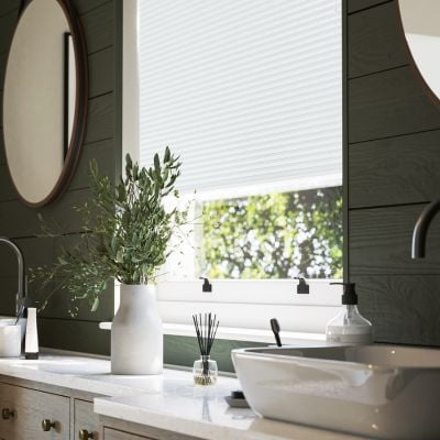 Pale blue pleated blind in a panelled bathroom