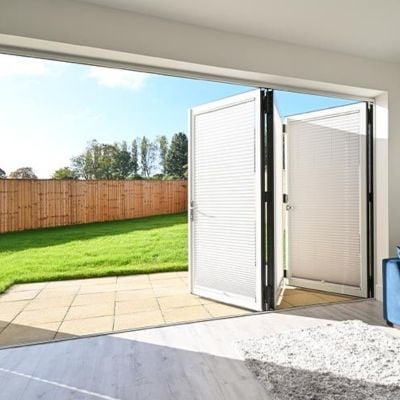 white, pleated no drill blinds on open bifold doors