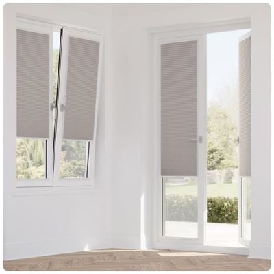 Pale pink pleated blinds on tilt-and-turn windows and a set of patio doors 