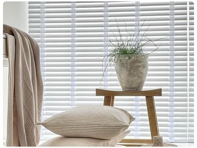 White wooden blinds in a dark grey panelled dining room 