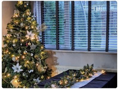 White wooden blinds in a dark grey panelled dining room 
