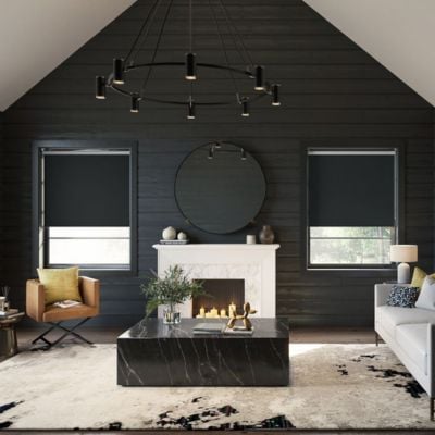 Black, blackout roller blinds in a black panelled living room 