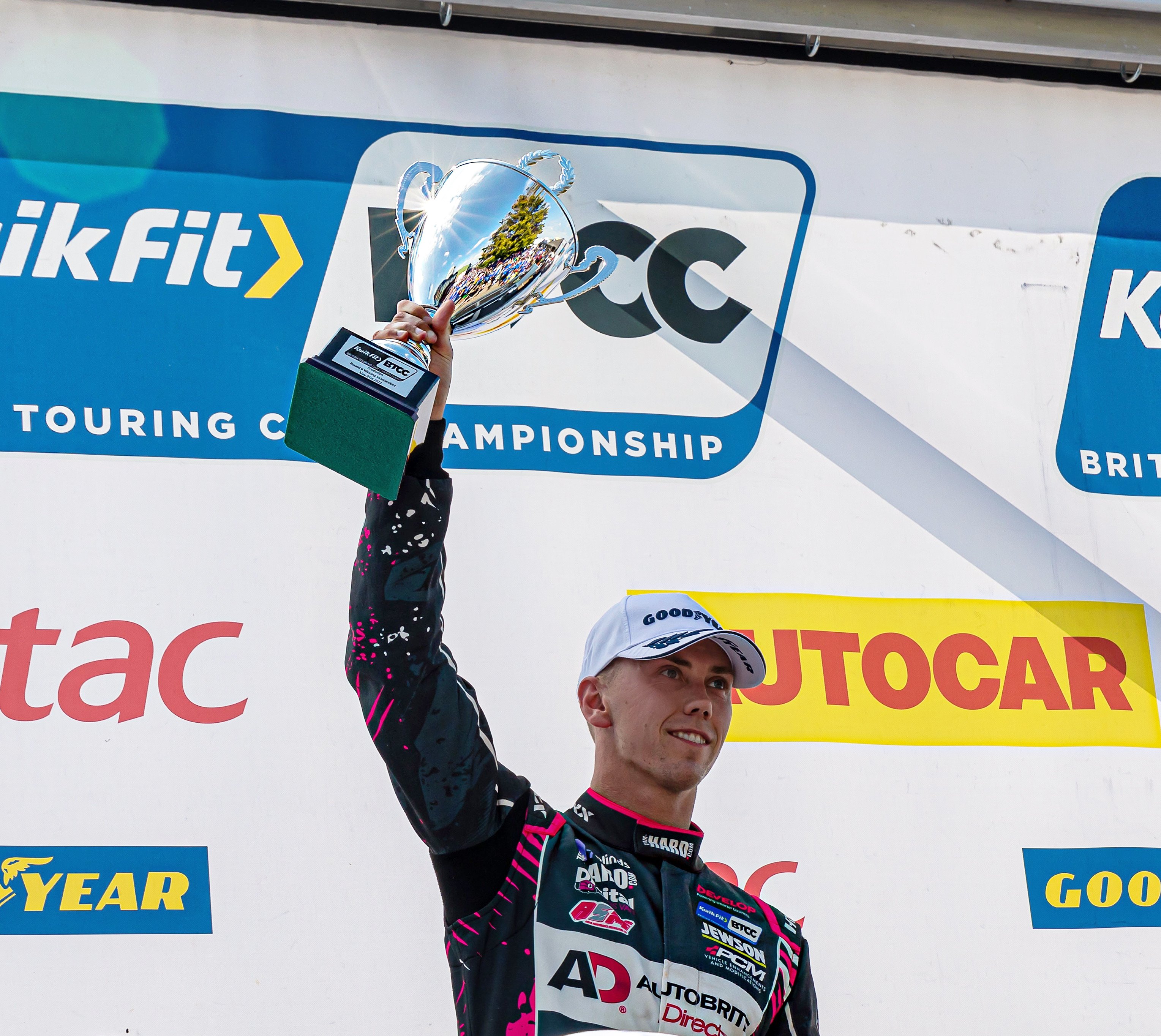 Dan Lloyd holding up his BTCC trophy
