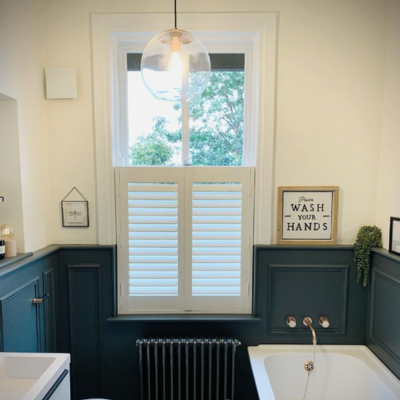 cafe style shutters in a blue and white bathroom 