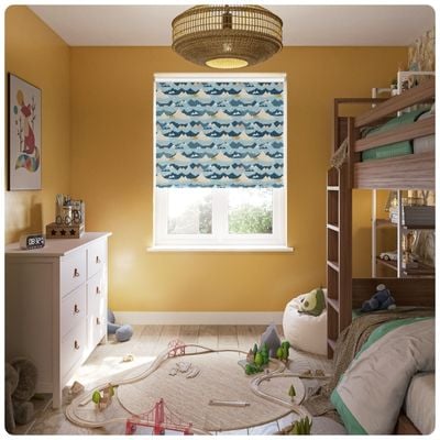 A blue children's roller blind with cartoon mountains in a kids room 