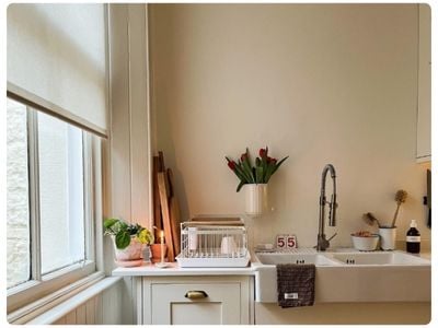 White wooden blinds in a dark grey panelled dining room 