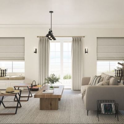 Beige curtains and roman blinds in a living room