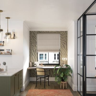Taupe roman blinds in a window above a desk