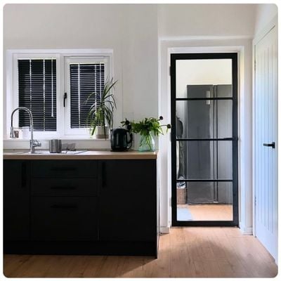 Black Venetian Perfect Fit blinds in a kitchen window 