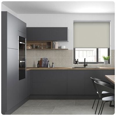 Beige electric roller blind in a kitchen window 