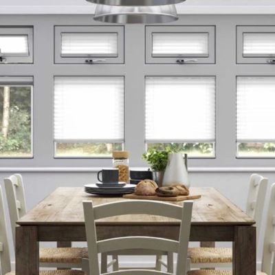 A white, clip fit pleated blind in a conservatory. 
