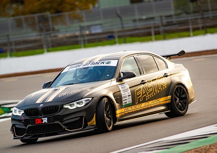 Dan Lloyd driving mid race in his black BMW