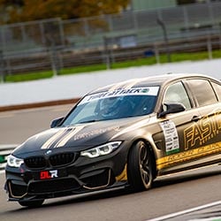 Dan Lloyd driving mid race in his black BMW