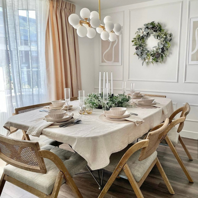 Floor to ceiling curtains in a Christmas decorated dining room