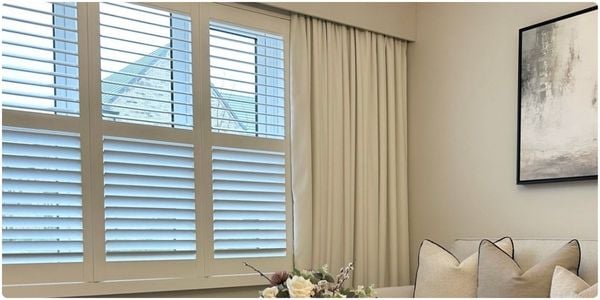 White wooden blinds in a white and wooden dining room