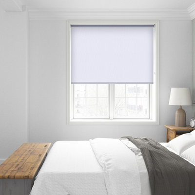 White modern bedroom with a white motorised blackout roller blind. 