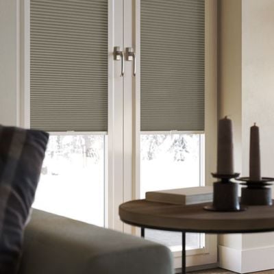 a dark grey, perfect fit pleated blind, on patio doors in a modern living room.