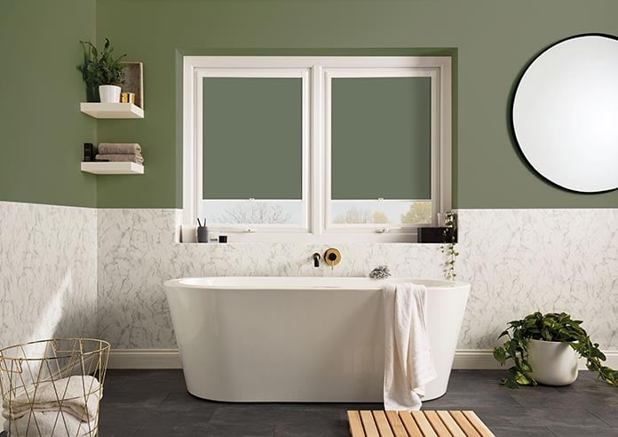 An image showing two green perfect fit roller blinds with green walls