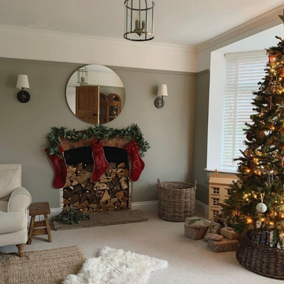 Traditional red and gold Christmas tree and stockings on mantelpiece
