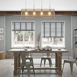 A dining room with a double grey taped wooden blind look