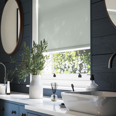 Sage grey roller blind in panelled bathroom. 