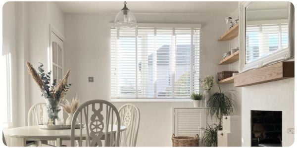 White wooden blinds in a white and wooden dining room