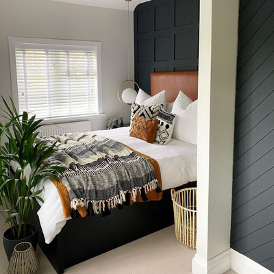 White wooden blinds shown in a bedroom
