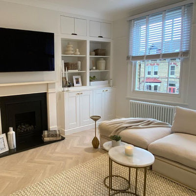 White wooden blinds with tapes shown in a neutral living room