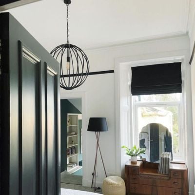 A black Roman blind in a Victorian style home