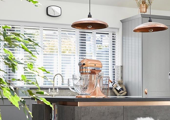 An image showing a wooden blind in a kitchen with copper interior