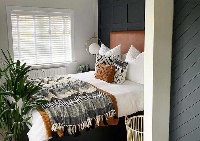 An image showing a bedroom with a wooden blind