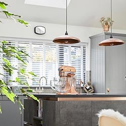 An image showing a wooden blind in a kitchen with copper interior