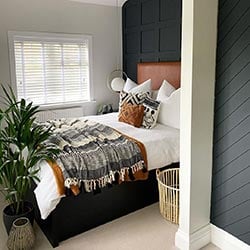 An image showing a bedroom with a wooden blind