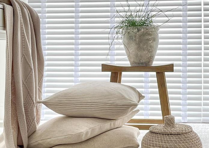 An image showing a bedroom with a wooden blind