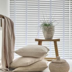 An image showing a bedroom with a wooden blind