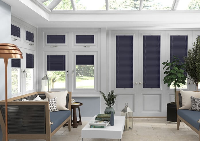 Blue pleated blind in a conservatory