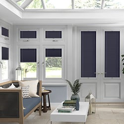 Blue pleated blind in a conservatory