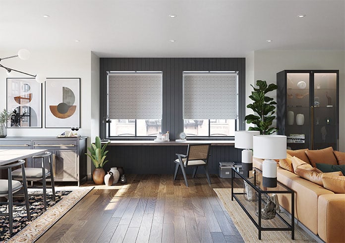 A pair of grey patterned roller blind a large open plan living room
