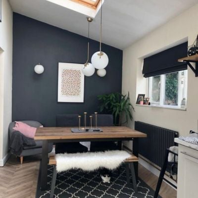 black roman blind fitted inside the recess in a dining room 