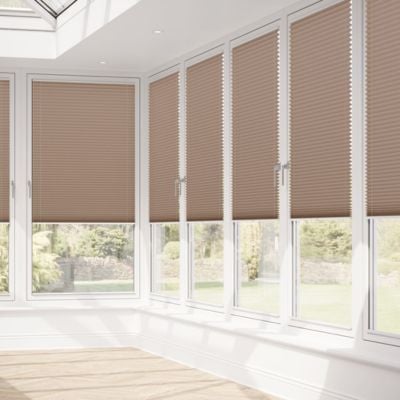 Brown, pleated no-drill window blinds on conservatory windows. 