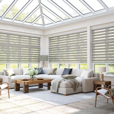 Taupe day night blinds in a bright and neutral conservatory.