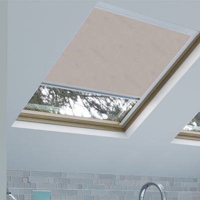 Pale pink loft blind fitted to a skylight